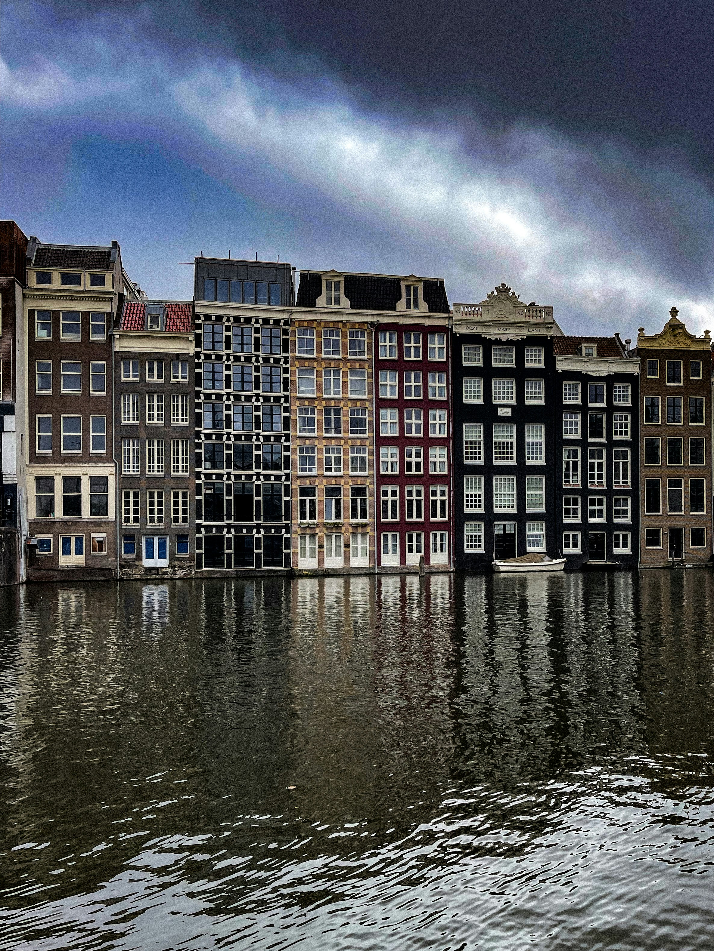 A row of buildings sitting next to a body of water