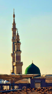 A tall building with a green dome on top of it