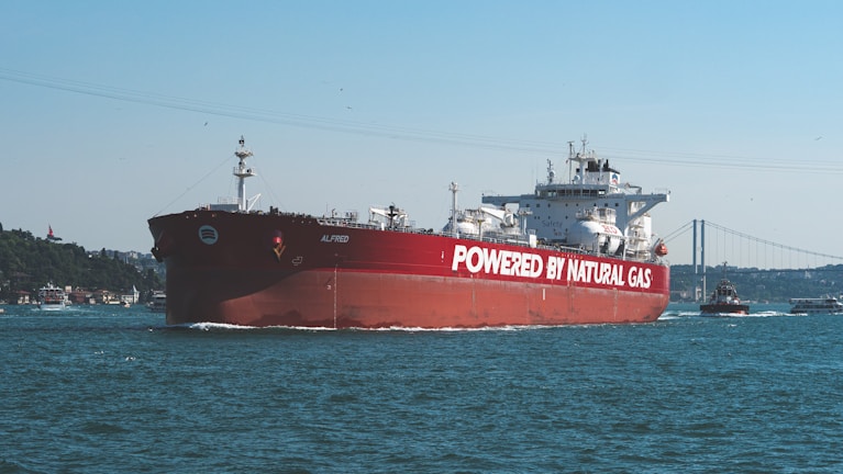A large red boat in the middle of a body of water