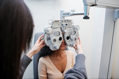 A woman sitting in a chair looking at a machine