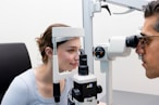 A man and a woman looking through a microscope