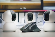 A group of three cameras sitting on top of a table