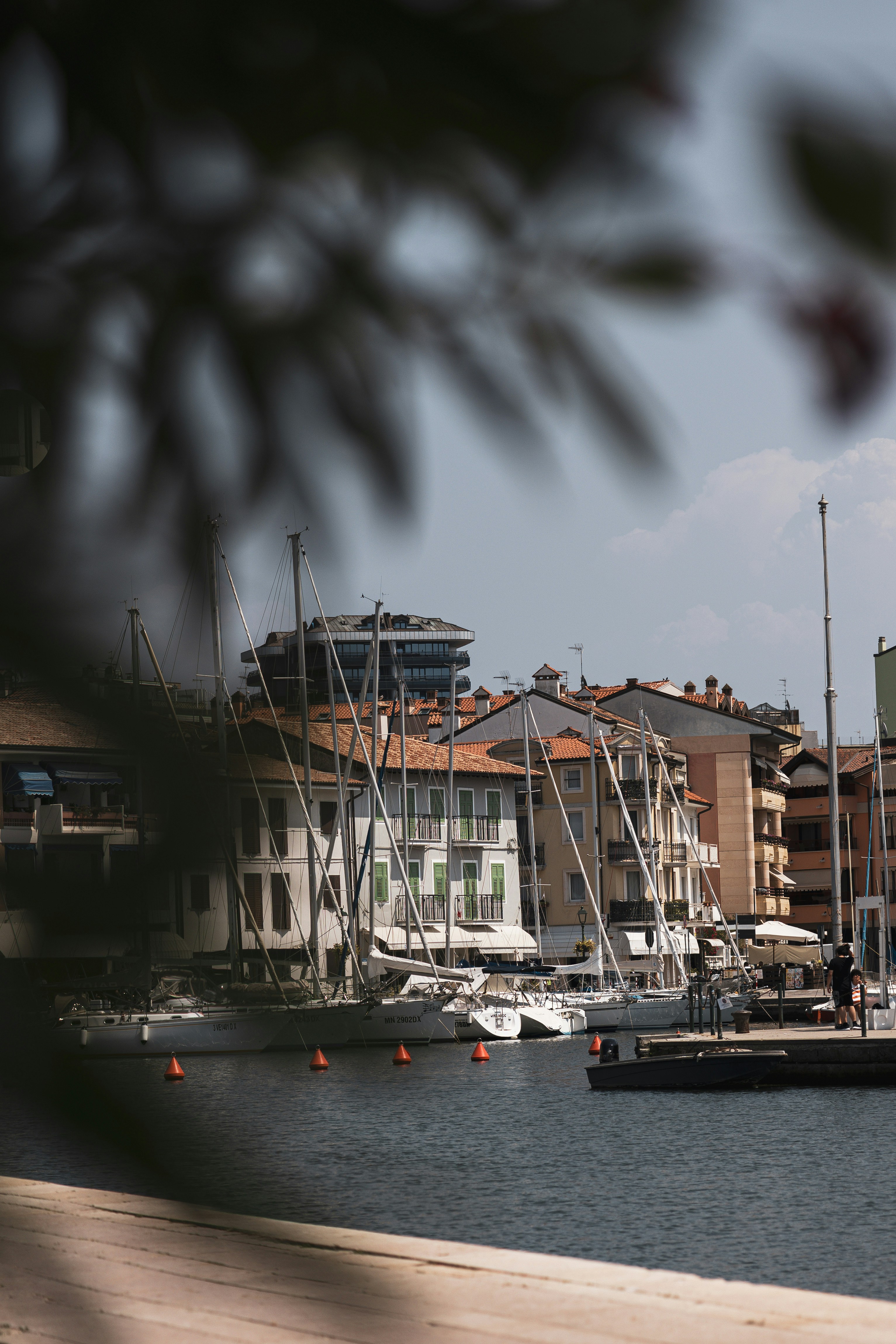 A harbor filled with lots of boats next to tall buildings
