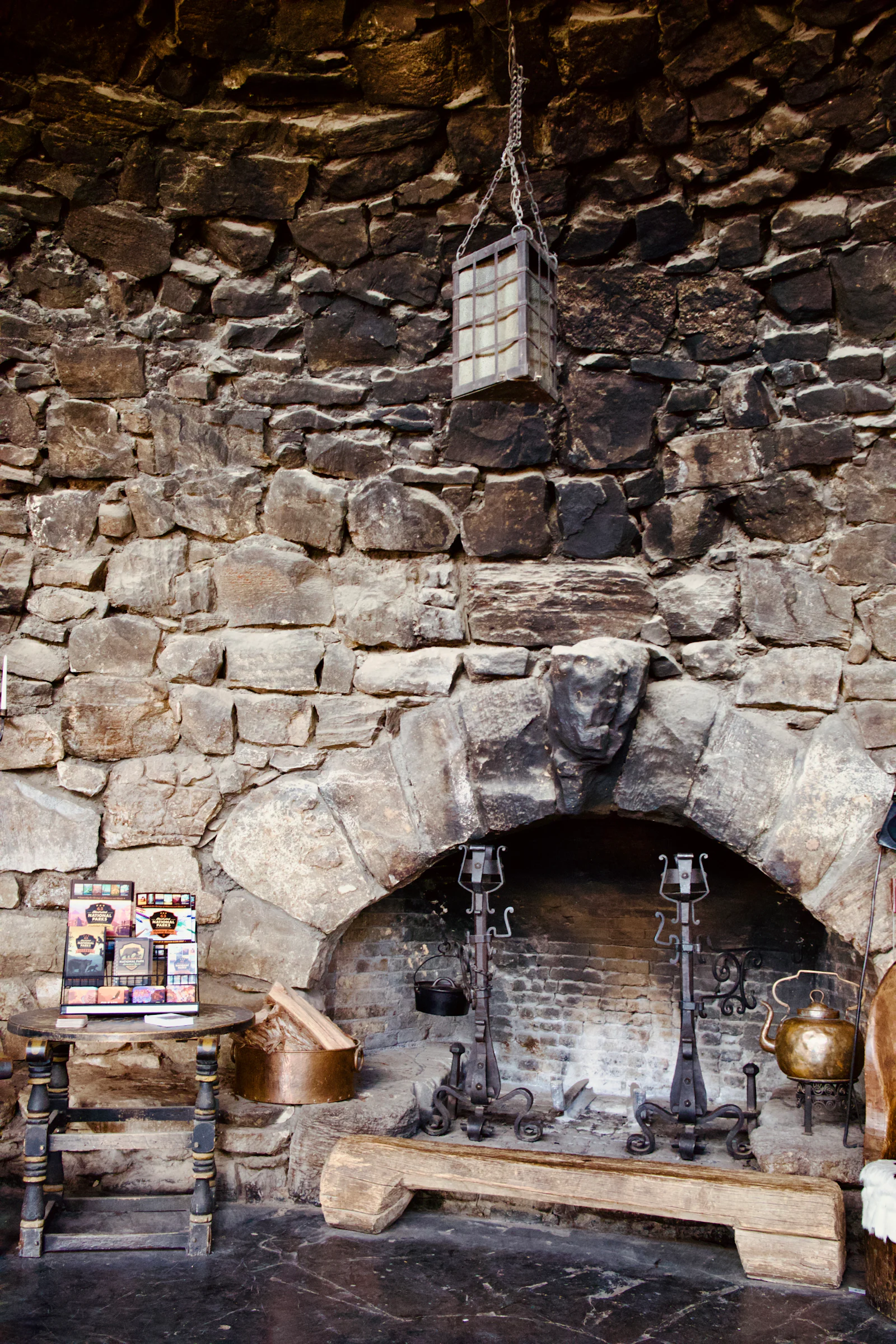 A stone fireplace set into a stone wall.