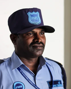 A man in a police uniform with a hat on