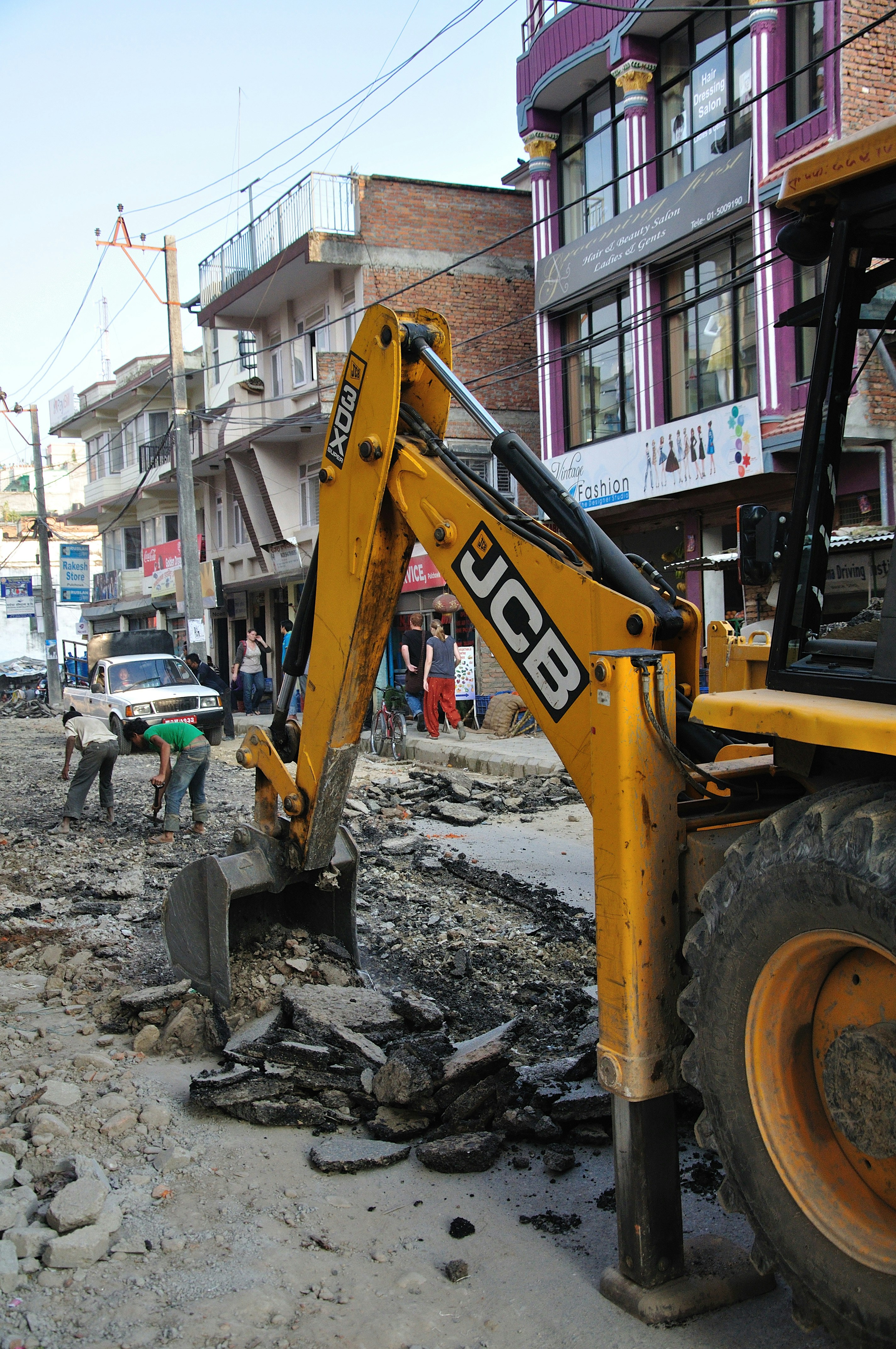 Yellow JCB excavator machine at construction site doing earthwork digging