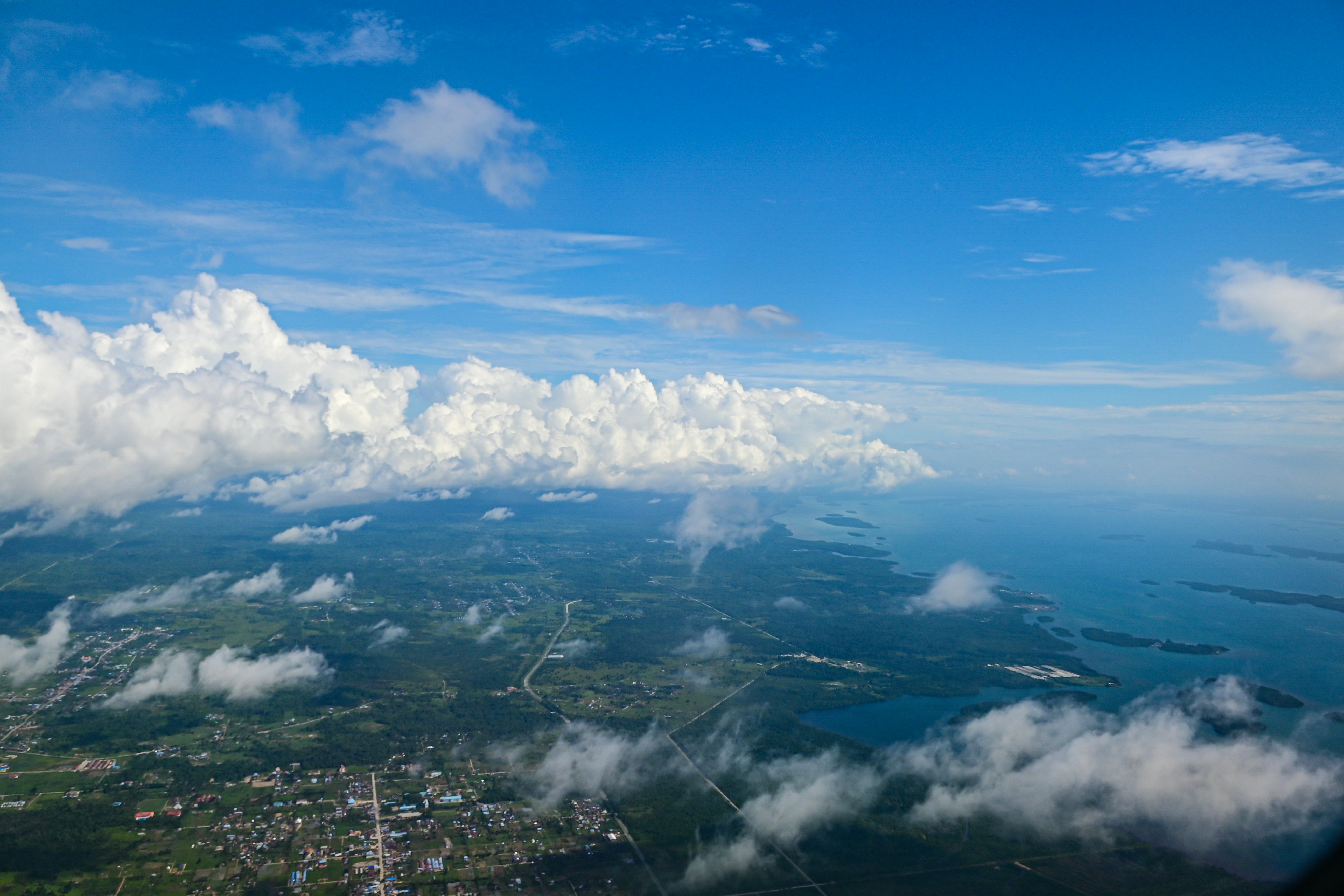 A view from a plane of clouds over a city