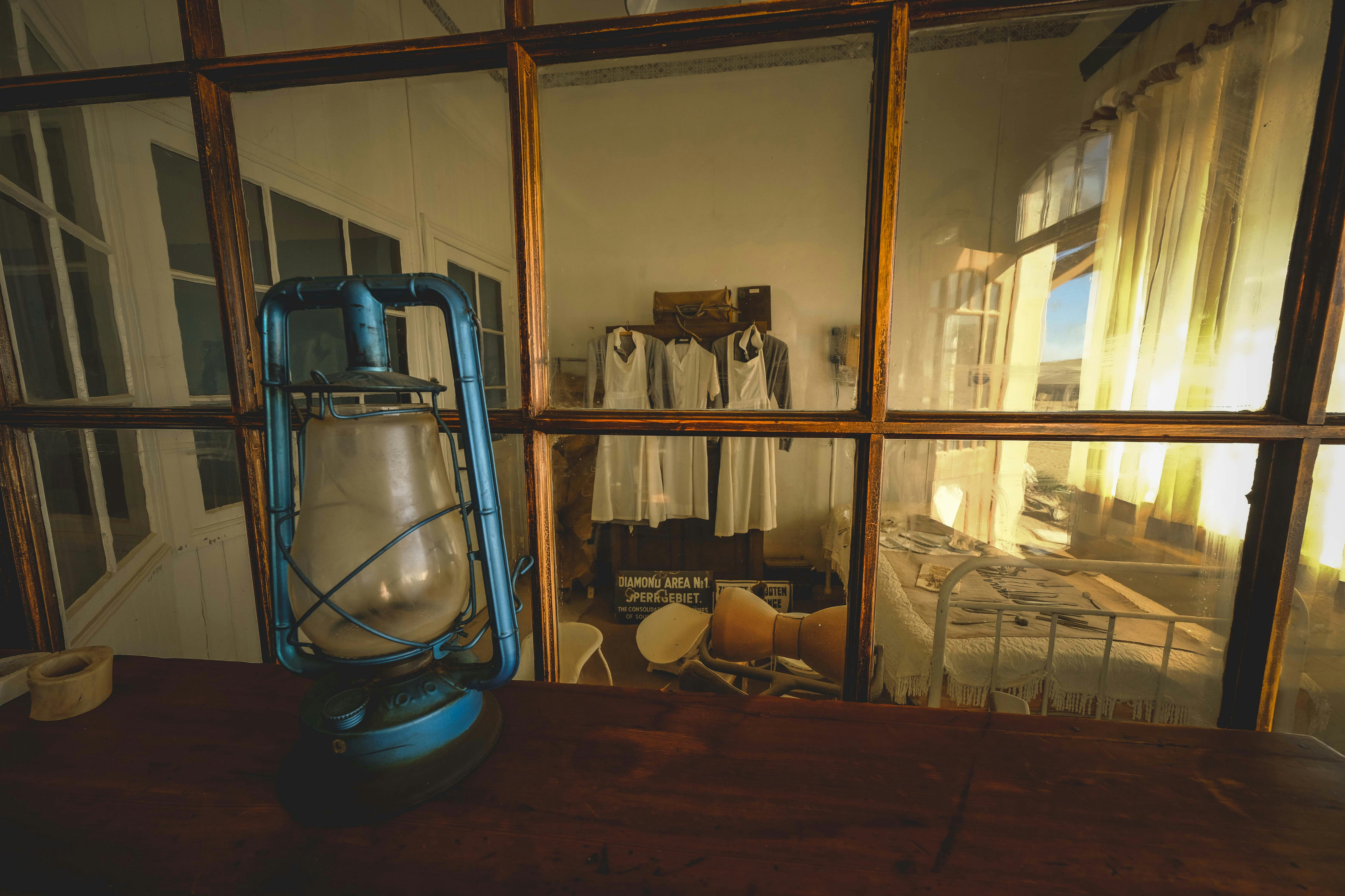 A blue lantern sitting on top of a wooden table
