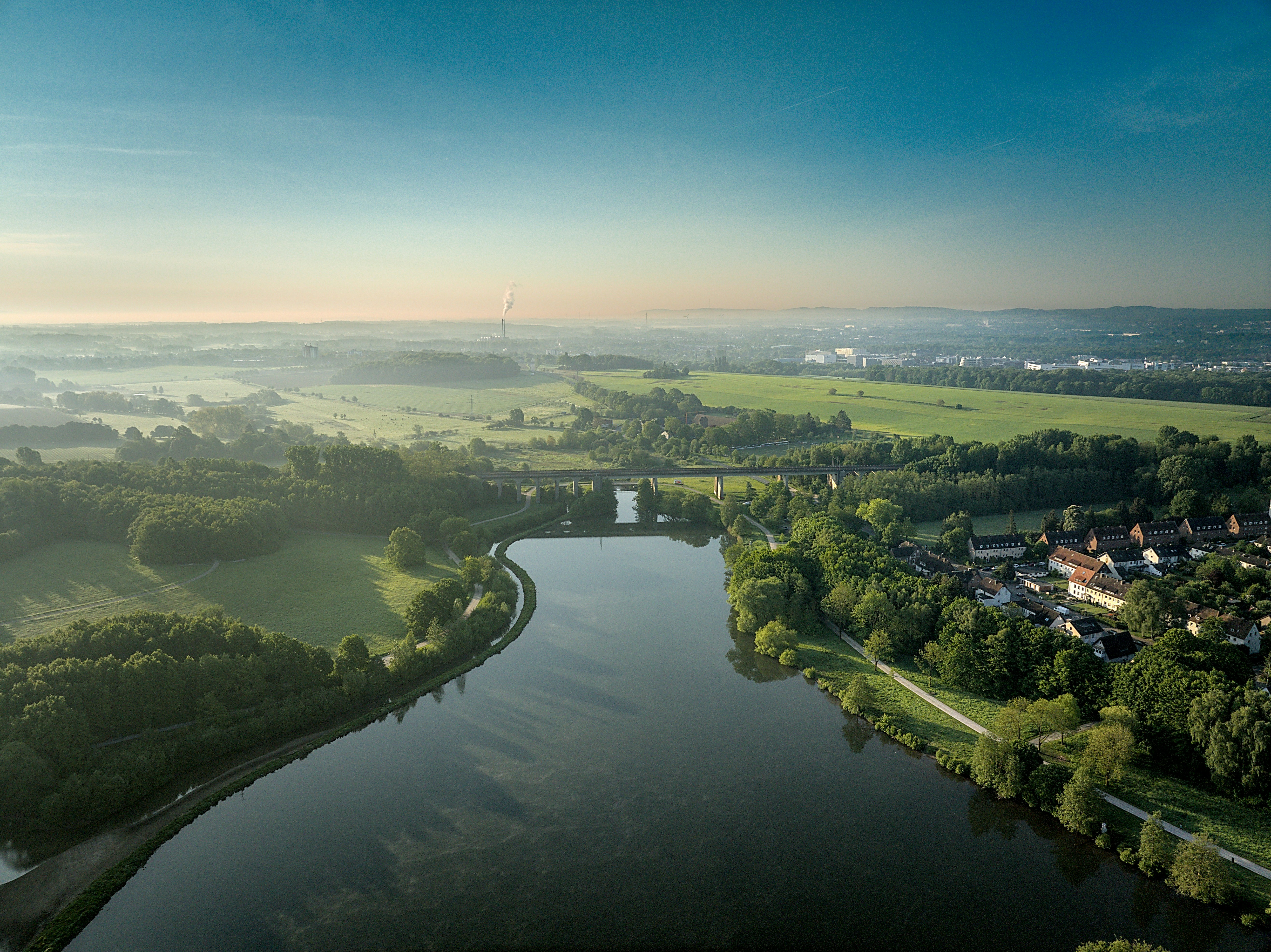 A river running through a lush green countryside