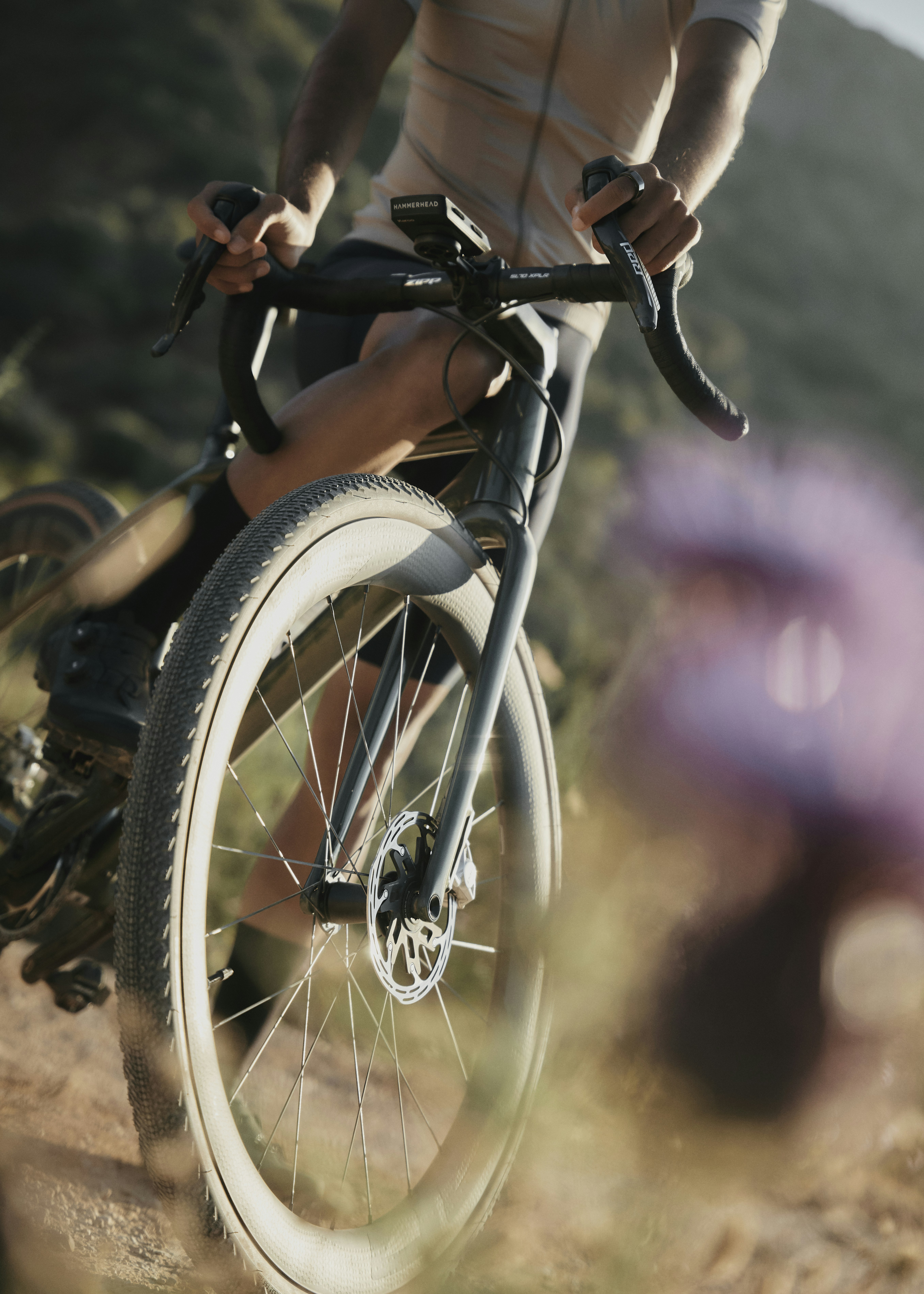 A man riding a bike down a dirt road