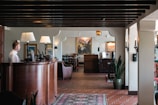A woman is standing at the front desk of a restaurant