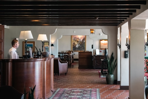 A woman is standing at the front desk of a restaurant