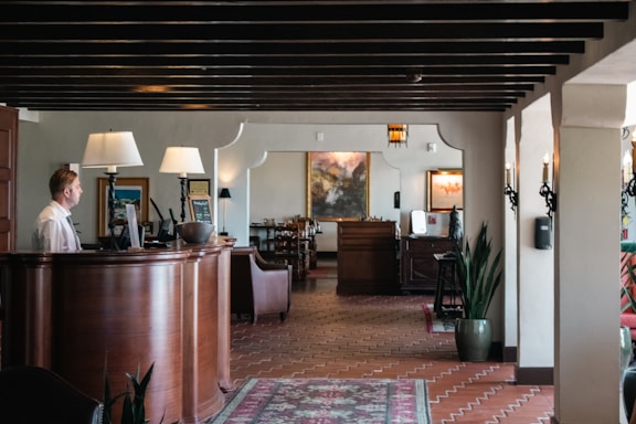 A woman is standing at the front desk of a restaurant