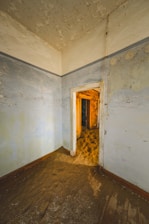 An empty room with a door leading to another room