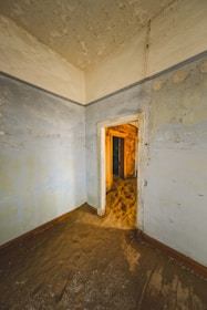 An empty room with a door leading to another room