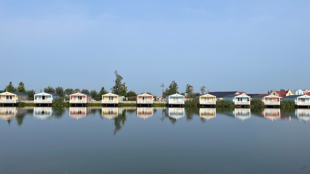 A body of water filled with lots of houses, Bungalows at water