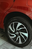 A close up of a red car parked on a street