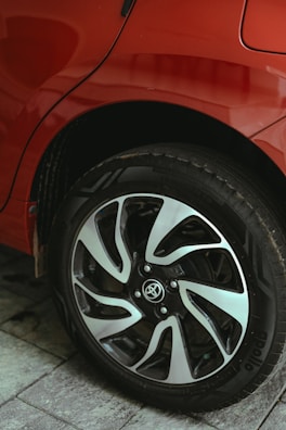 A close up of a red car parked on a street