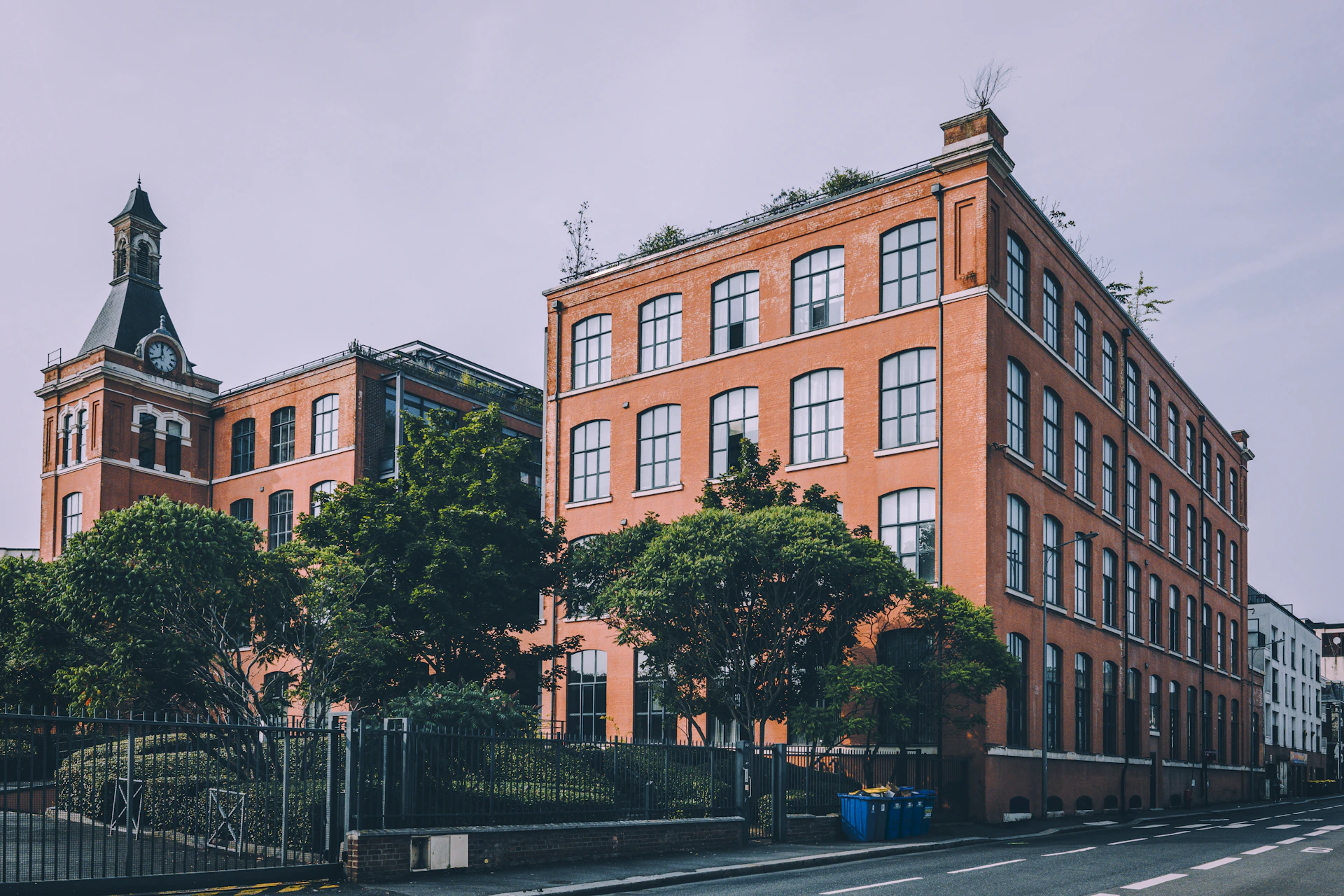 A red brick building sitting on the side of a road