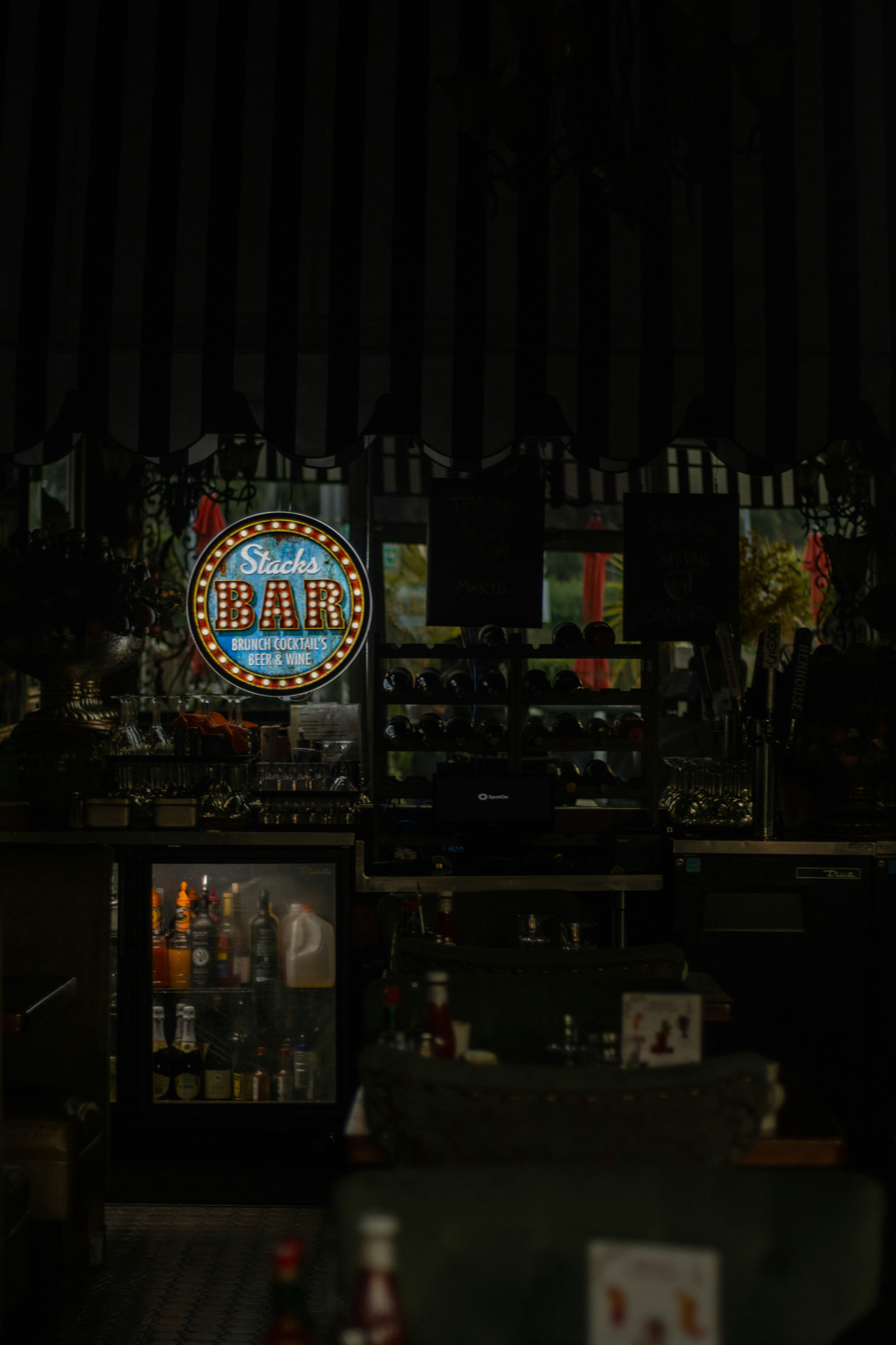 A bar with a neon sign on the wall