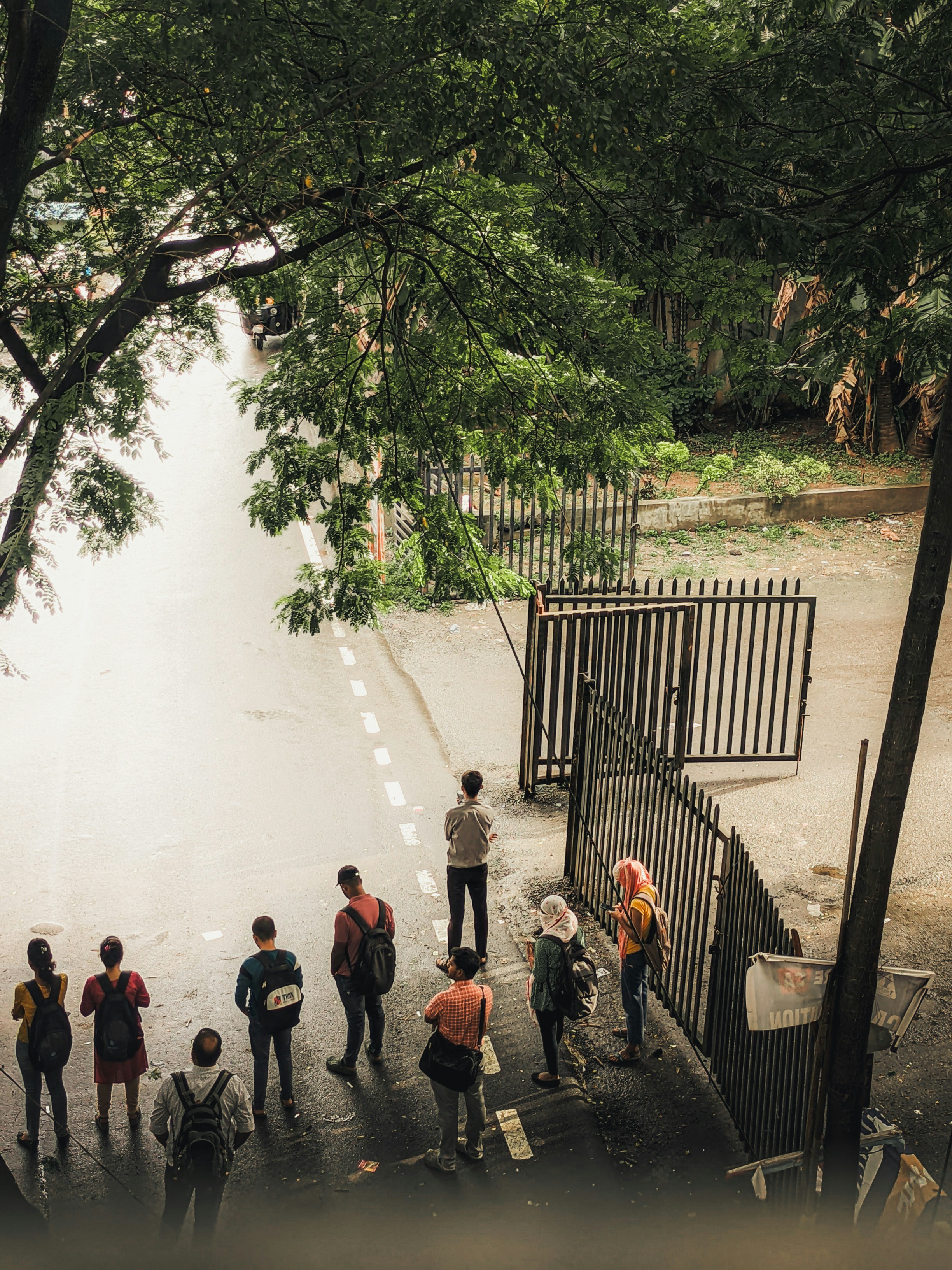 A group of people standing on the side of a road