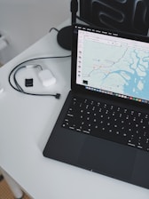 A laptop computer sitting on top of a white table