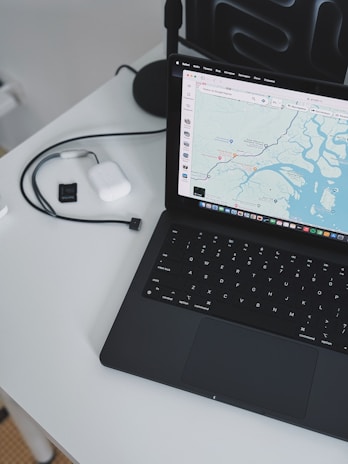 A laptop computer sitting on top of a white table