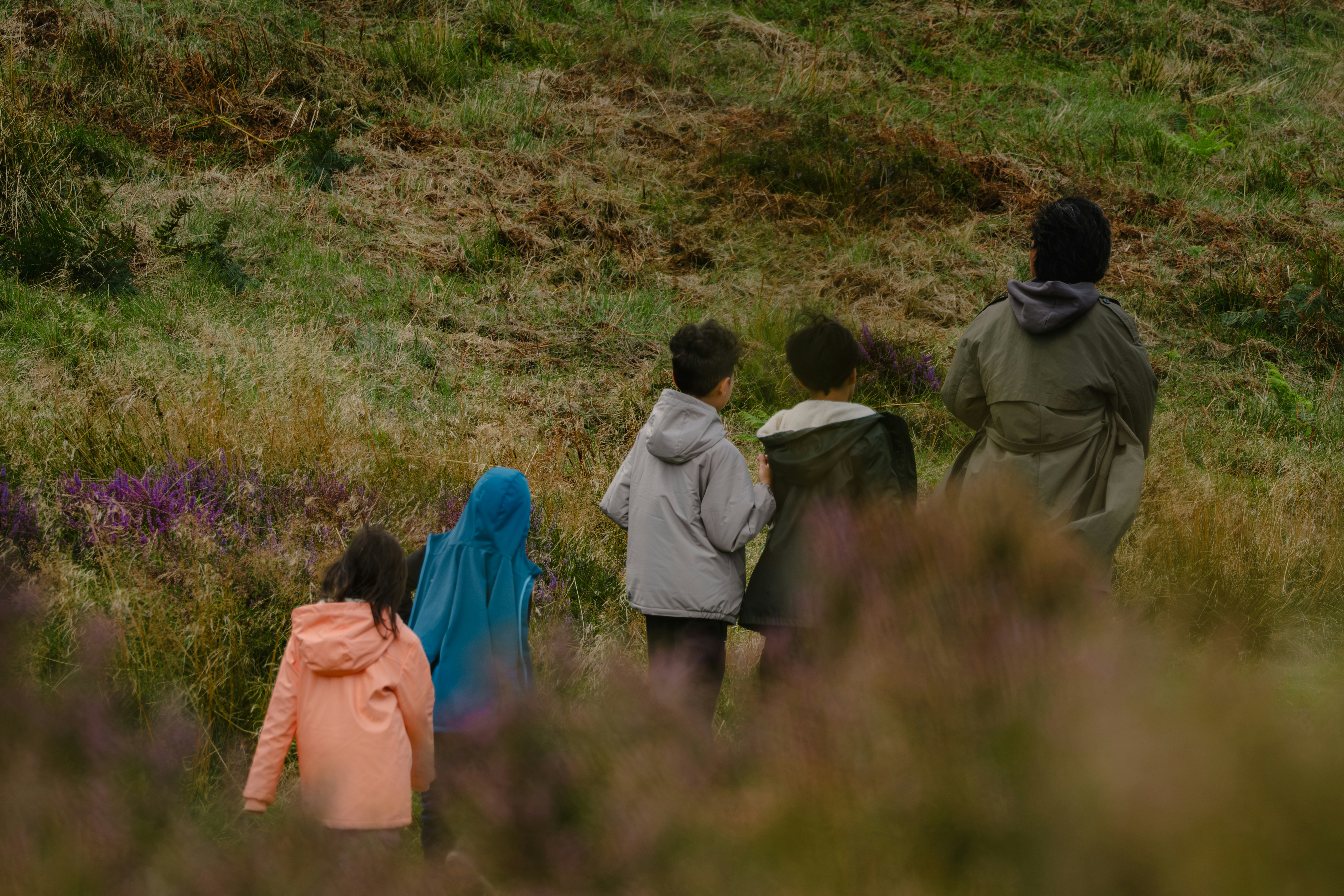 A group of people walking through a field