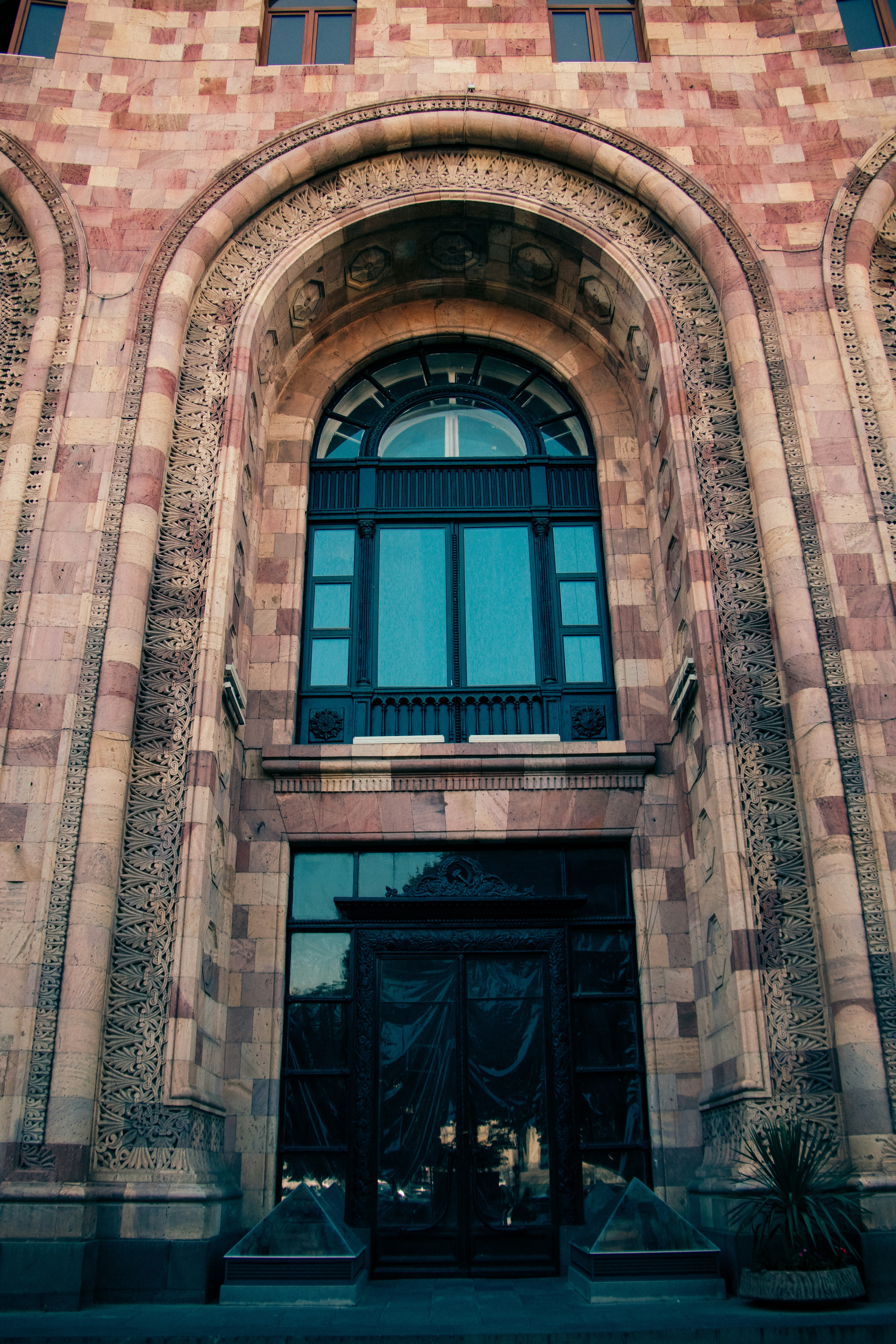 A tall brick building with a clock on the front of it