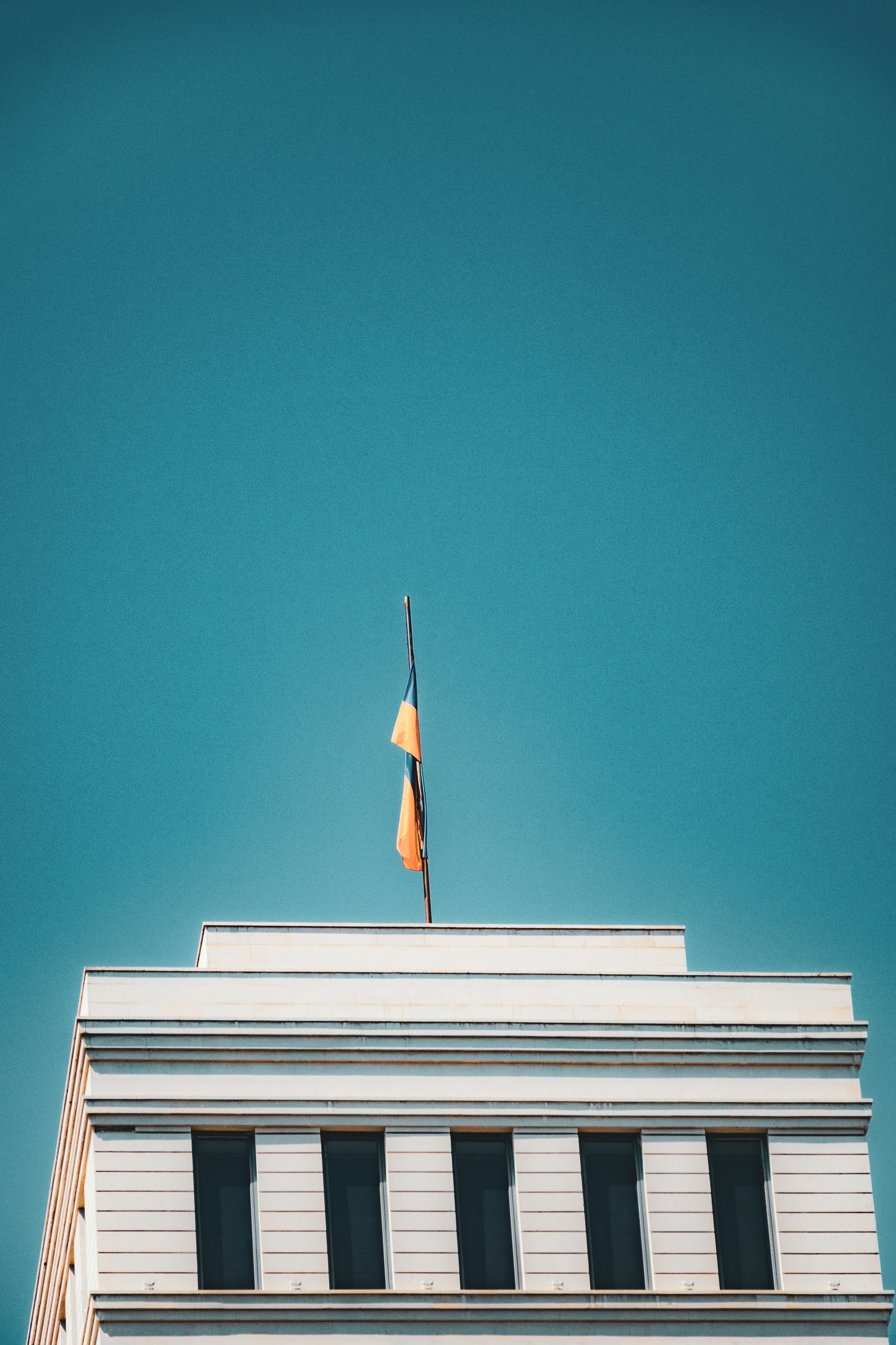 A tall building with a flag on top of it