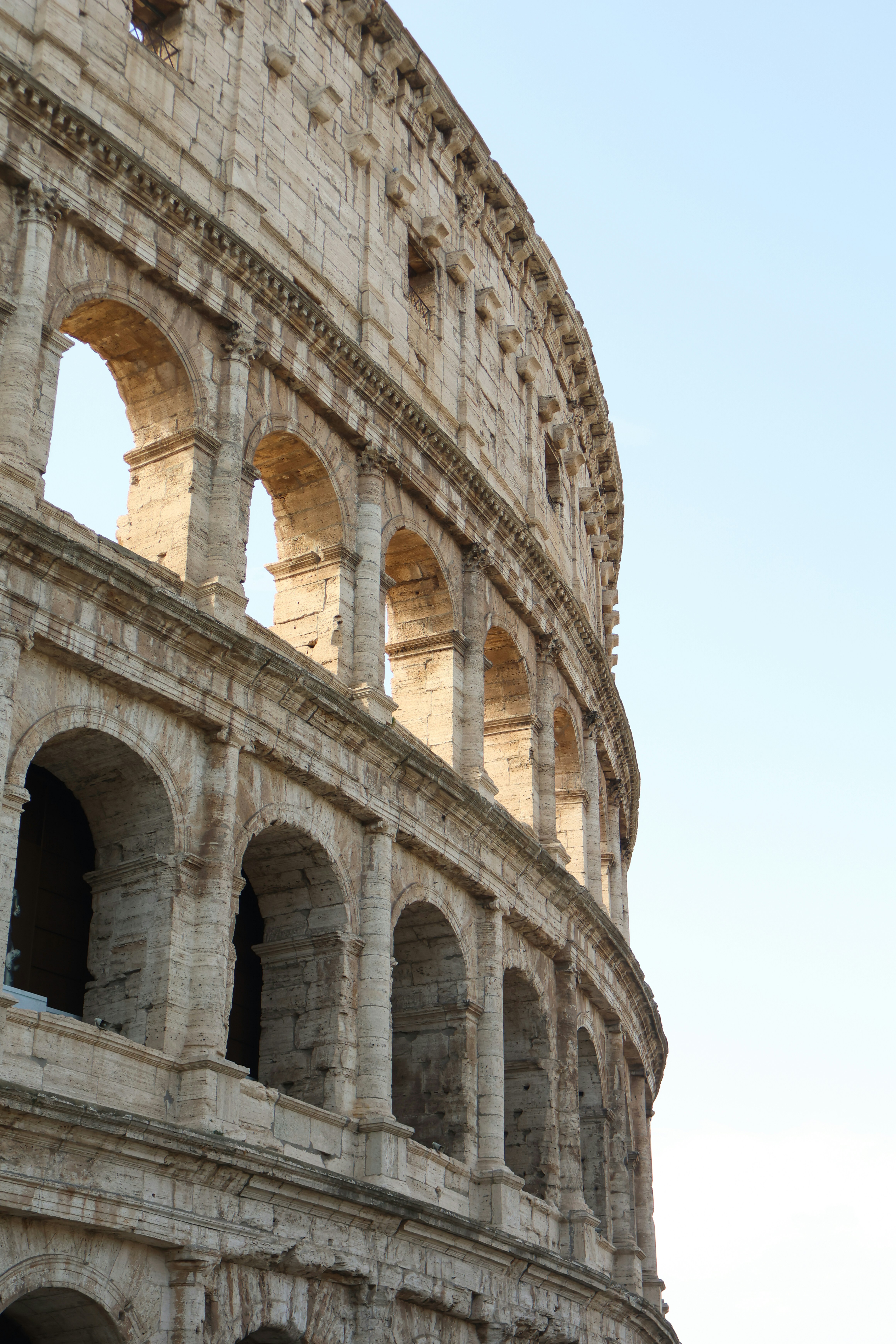 A large stone building with a clock on it's side