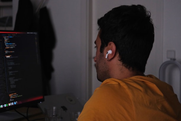 A man sitting in front of a computer monitor