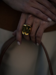 A close up of a person holding a handbag
