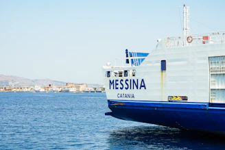 A large boat floating on top of a body of water