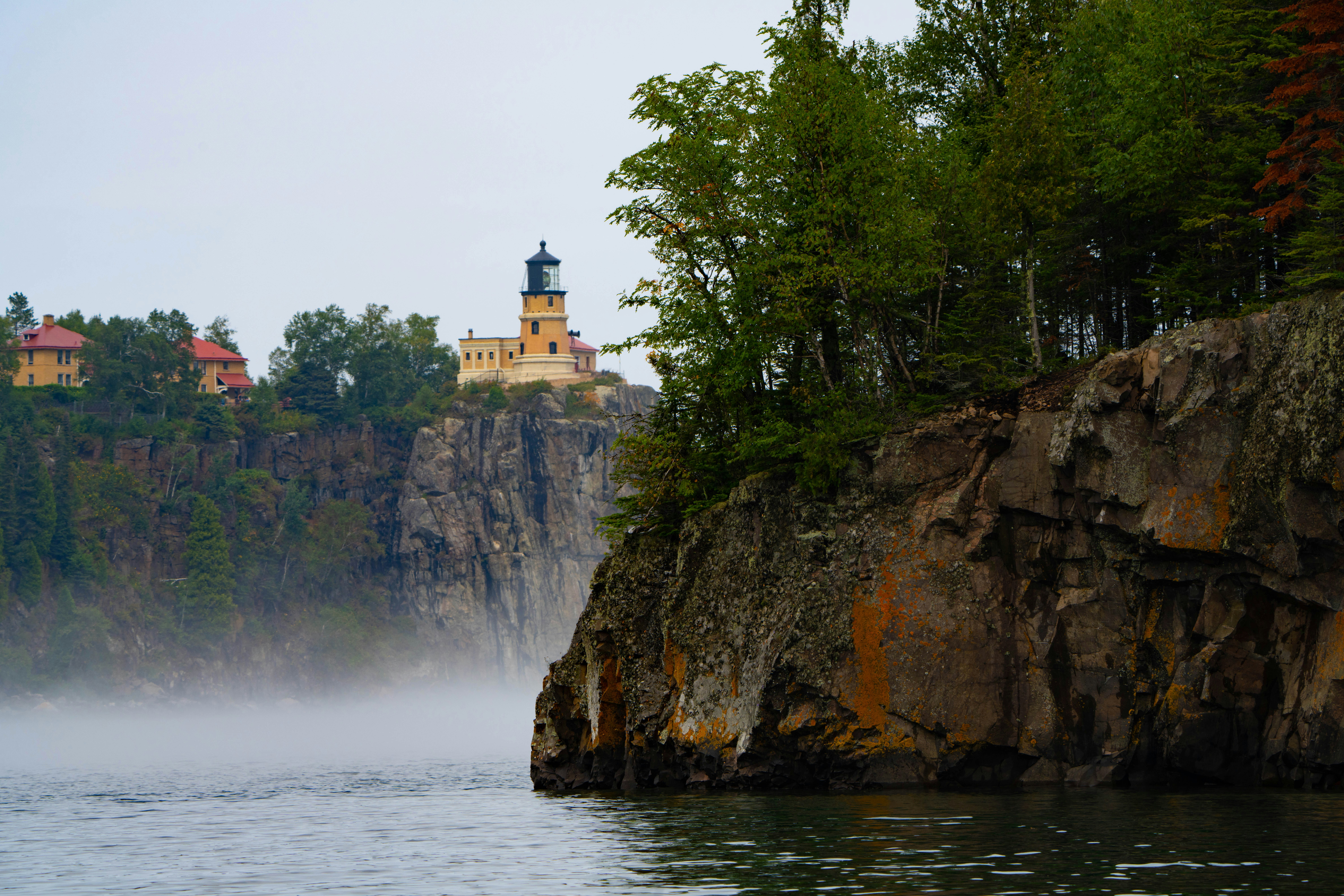 A large body of water with a lighthouse on top of it
