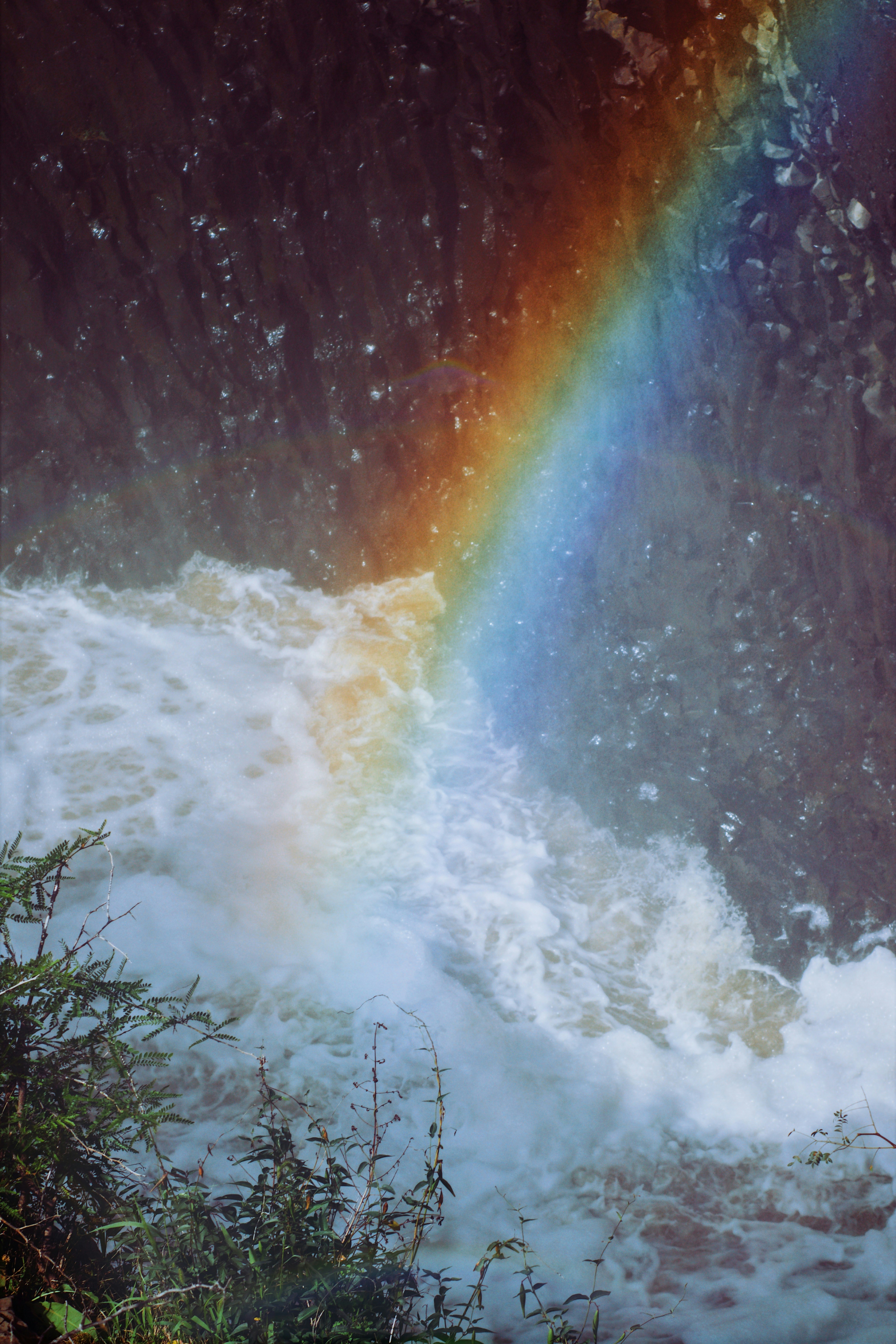 A rainbow in the middle of a waterfall