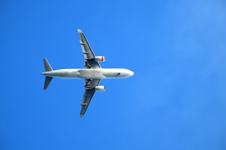 A large jetliner flying through a blue sky