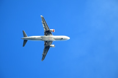 A large jetliner flying through a blue sky