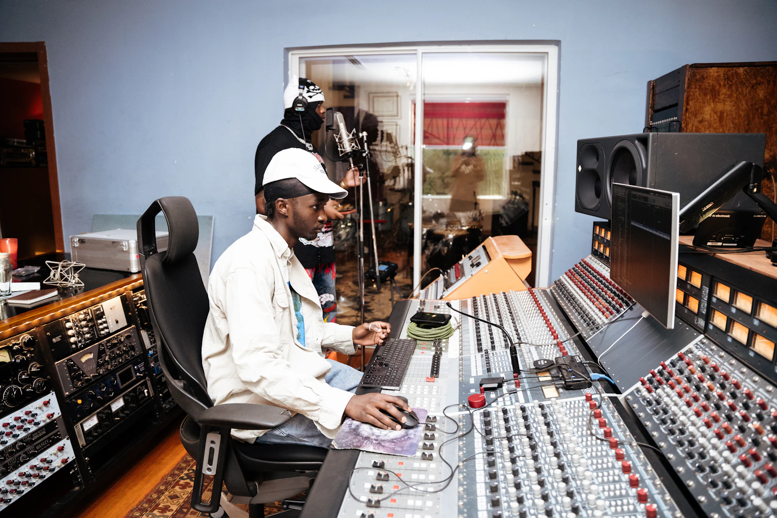 Artist and engineer working together at a recording studio mixing desk
