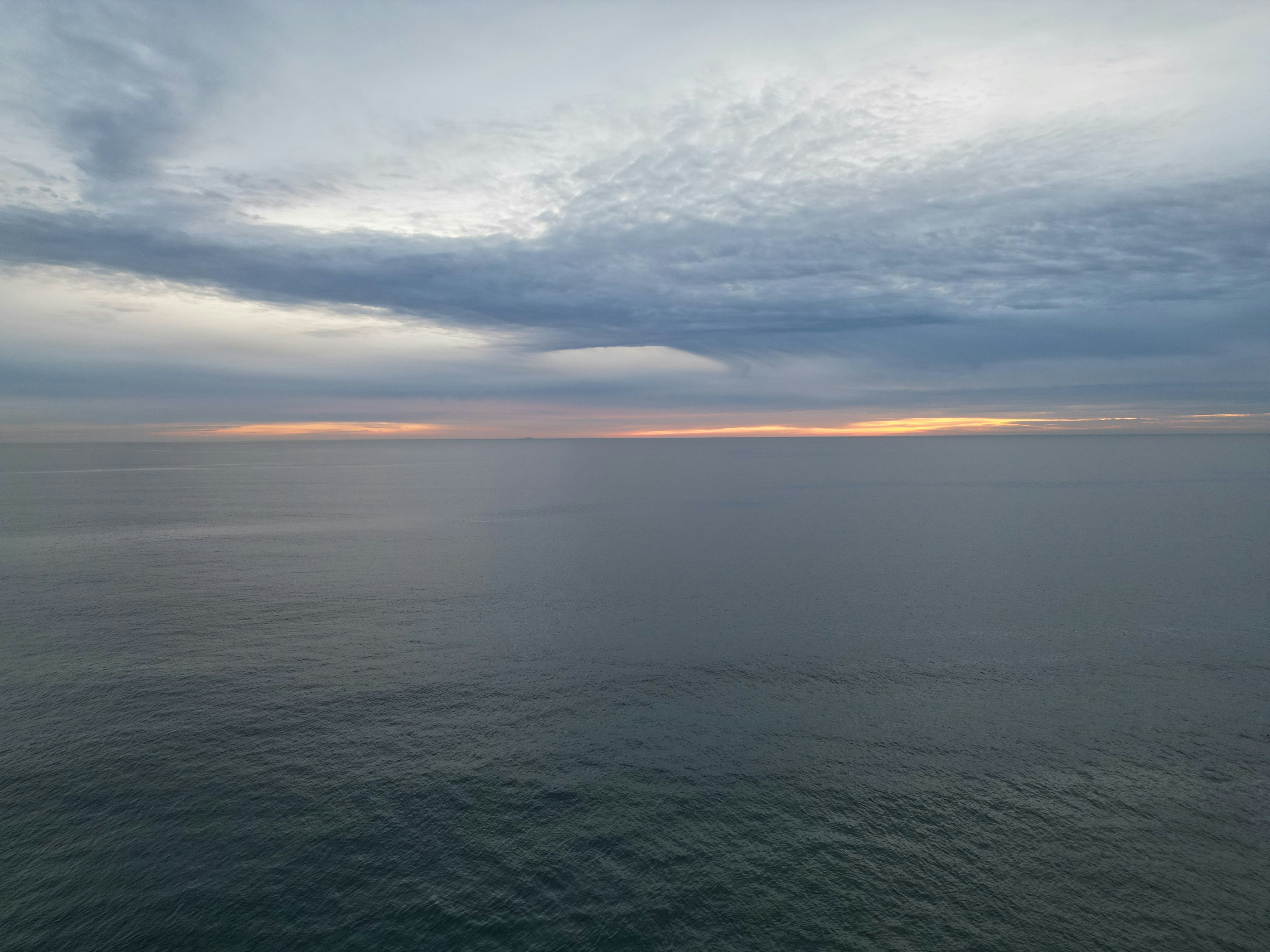 A body of water with a sky in the background