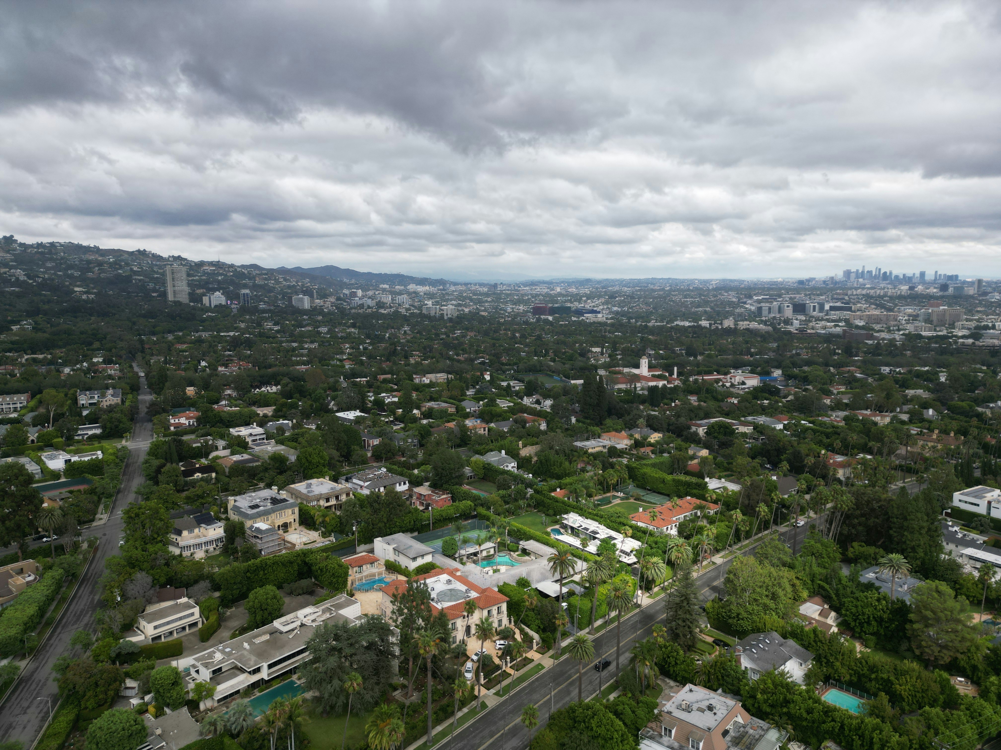 An aerial view of a city with a cloudy sky