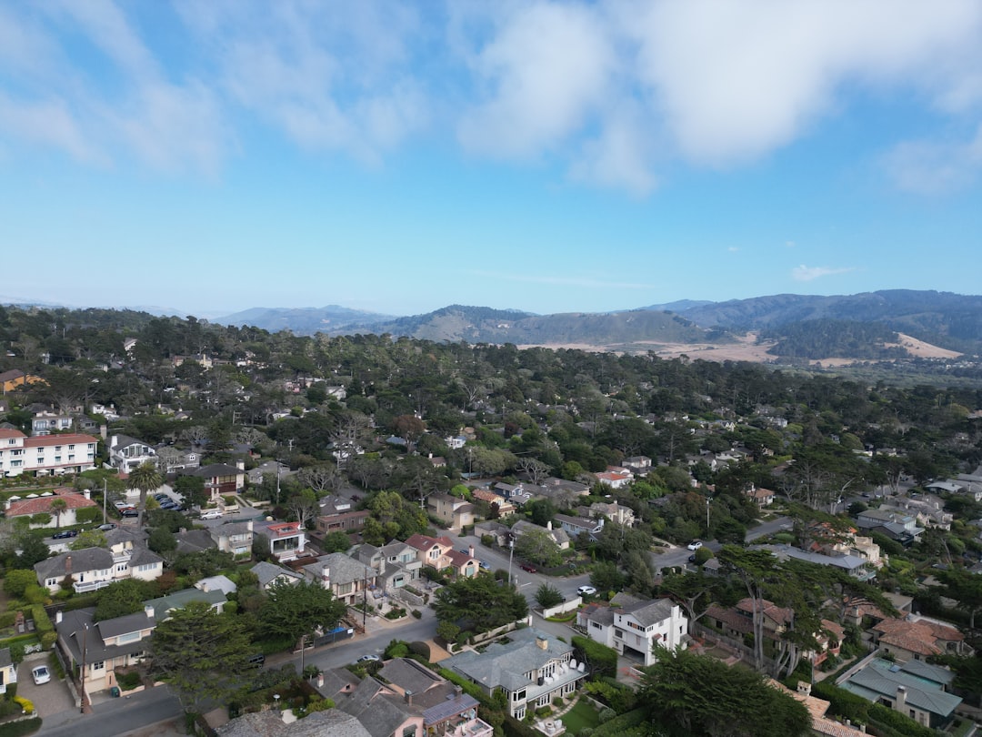 An aerial view of a city with mountains in the background,