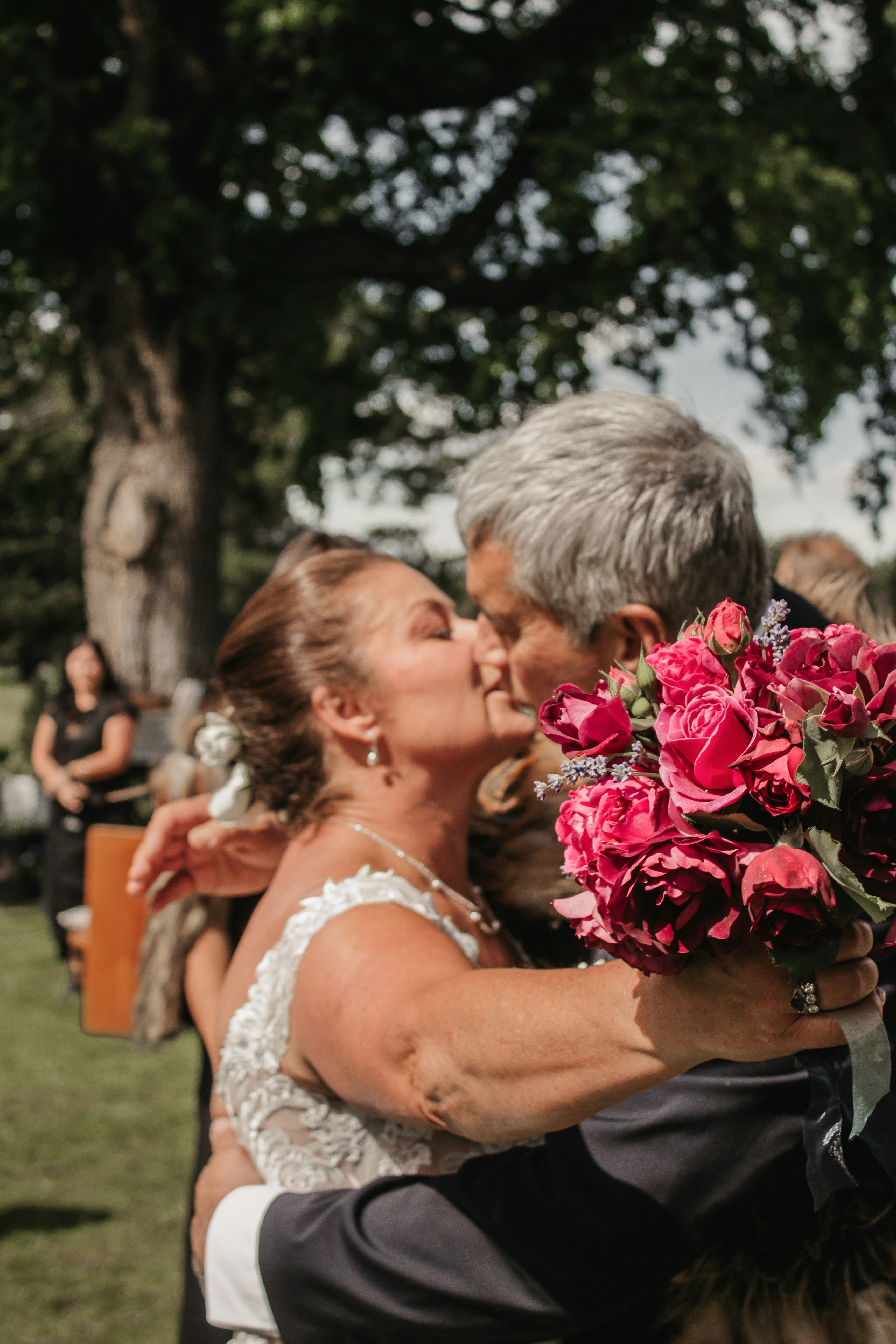 A man and woman kissing each other in front of a crowd