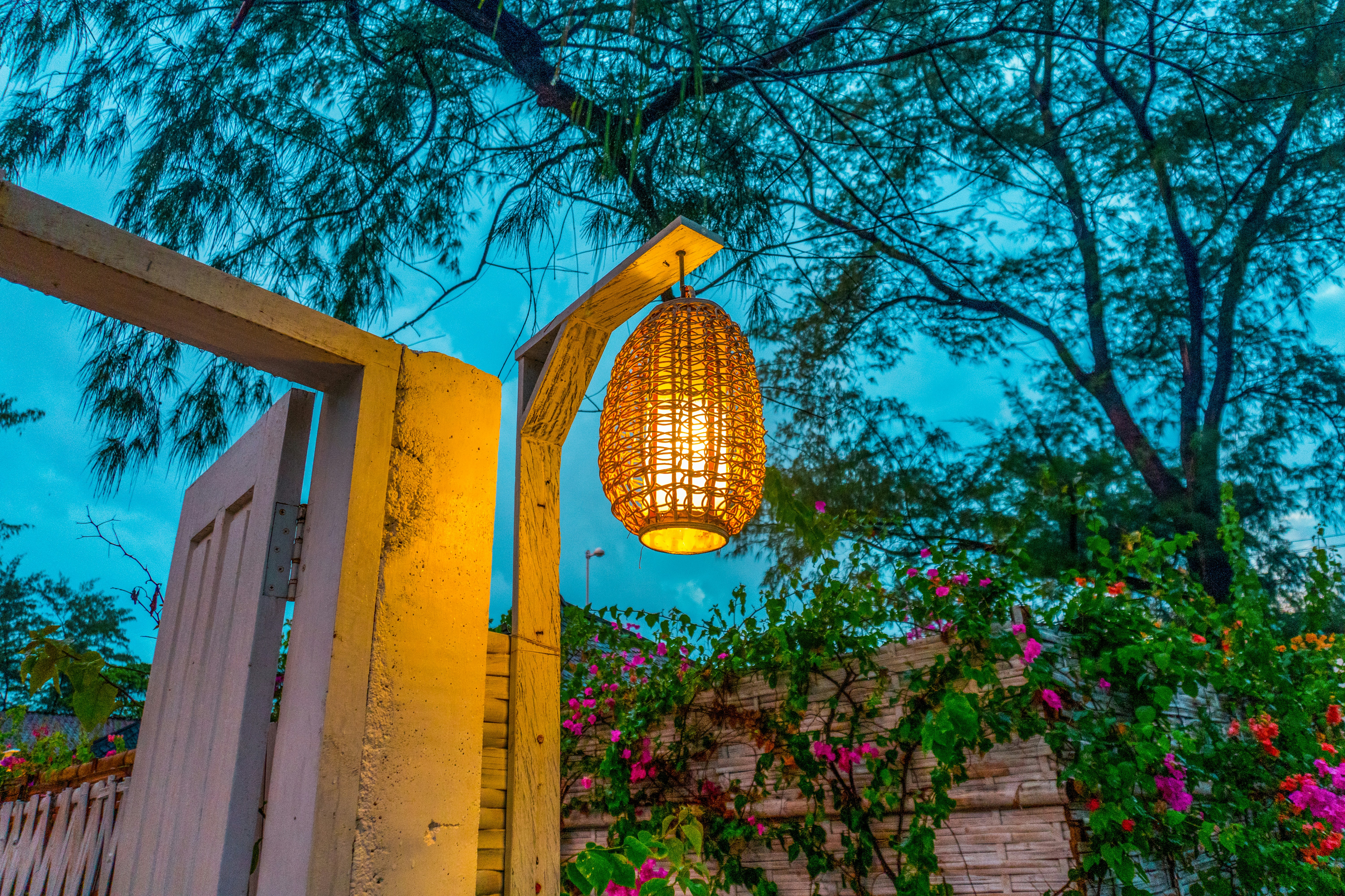 A lamp hanging from the side of a building