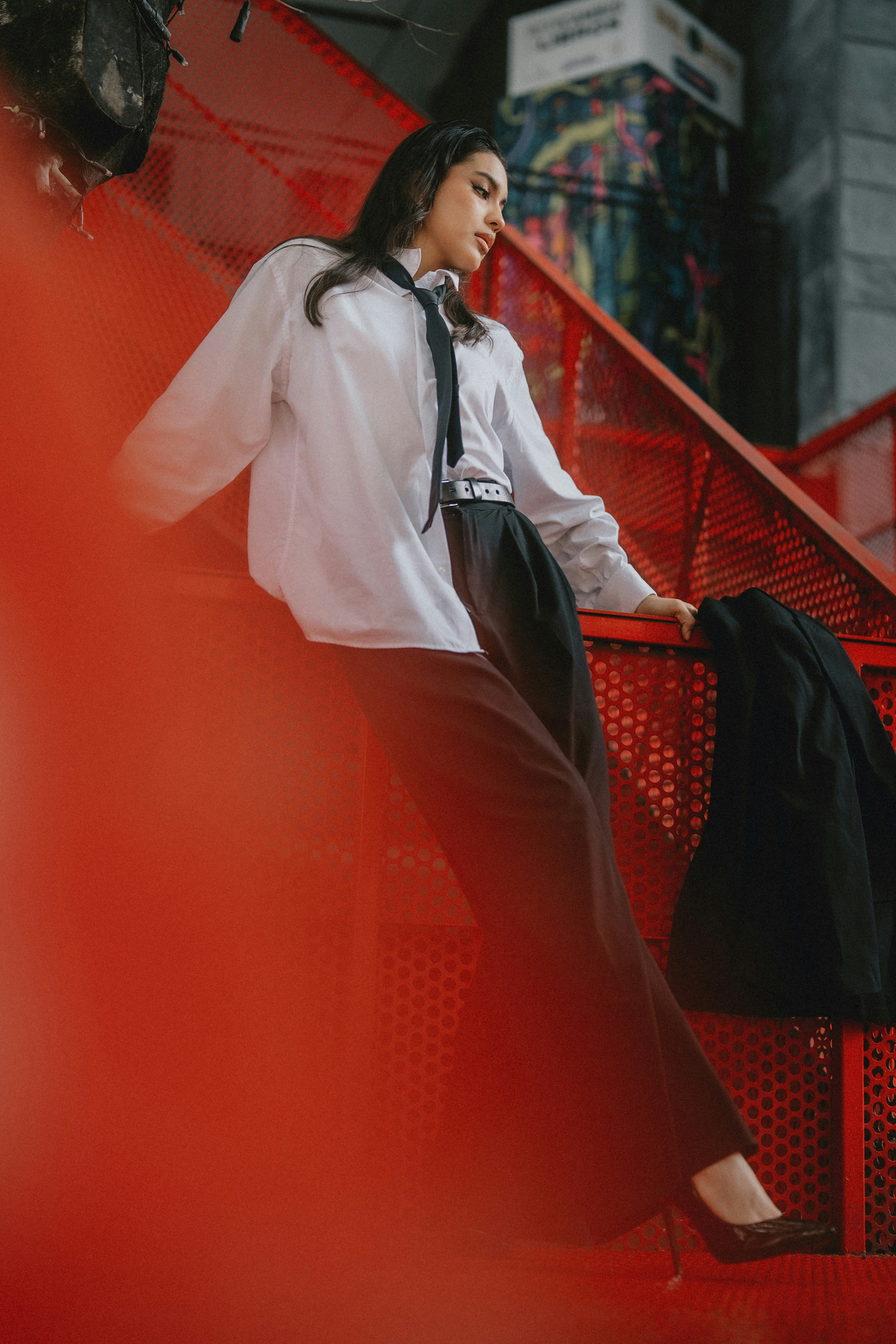 A woman in a white shirt and black pants