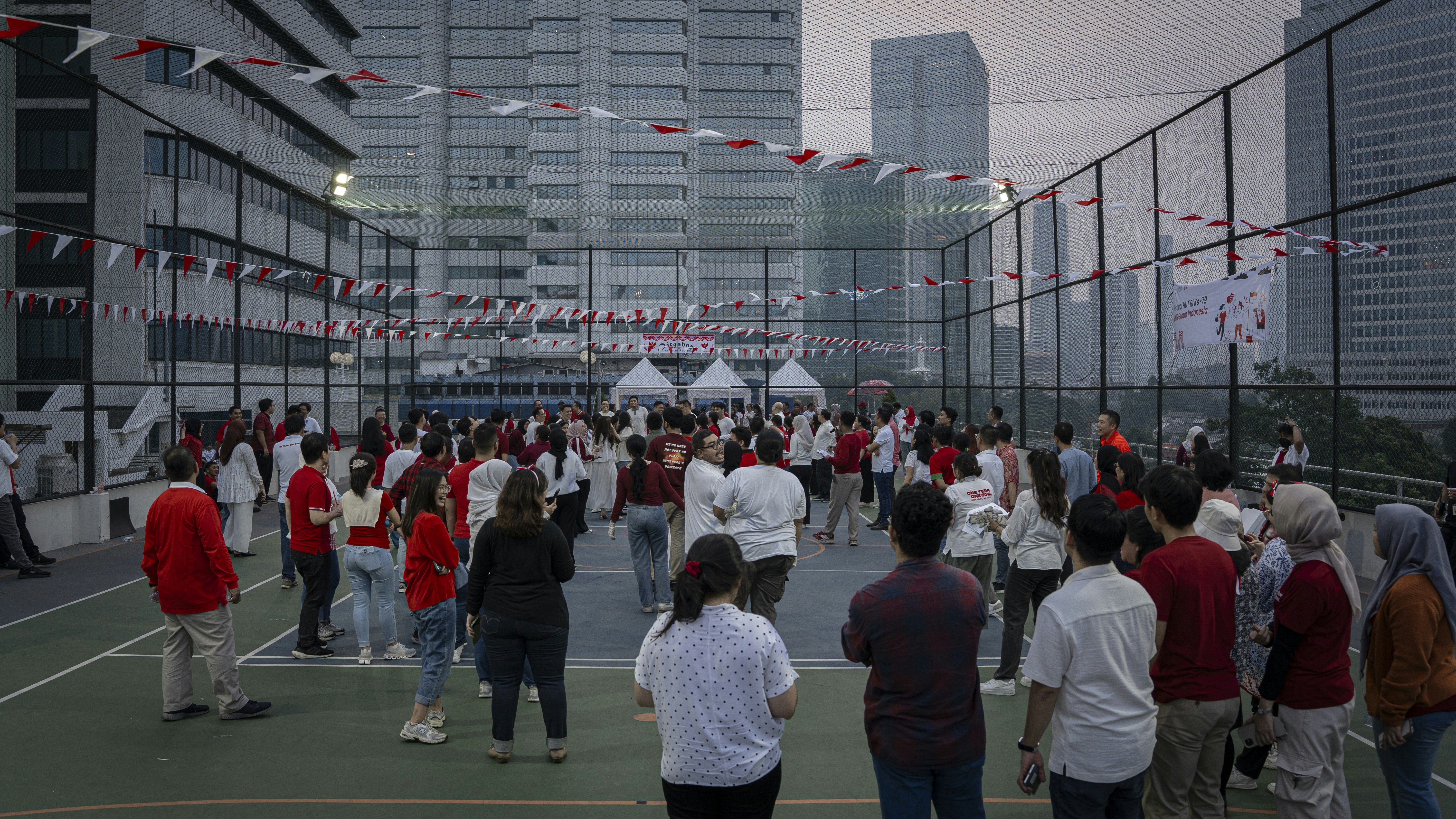 A group of people standing on top of a tennis court