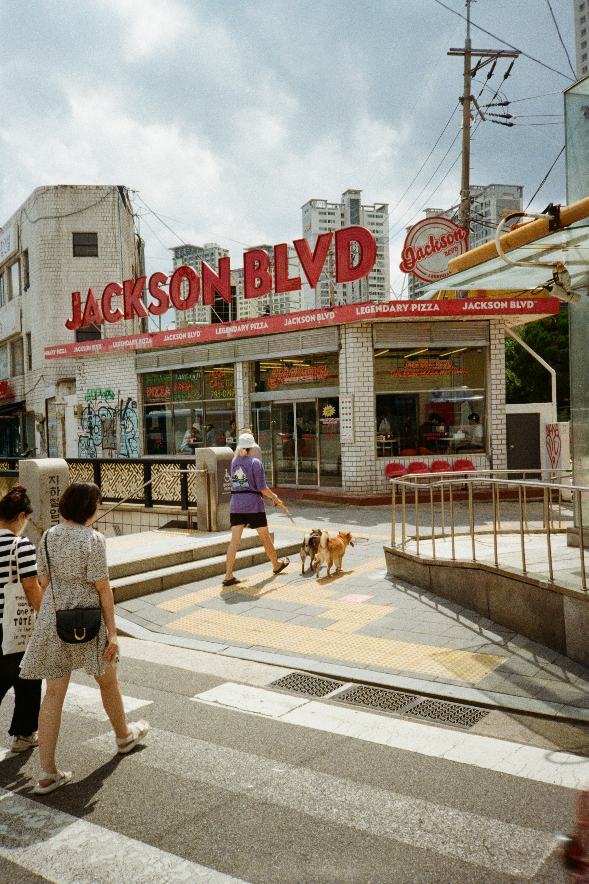A group of people walking across a cross walk