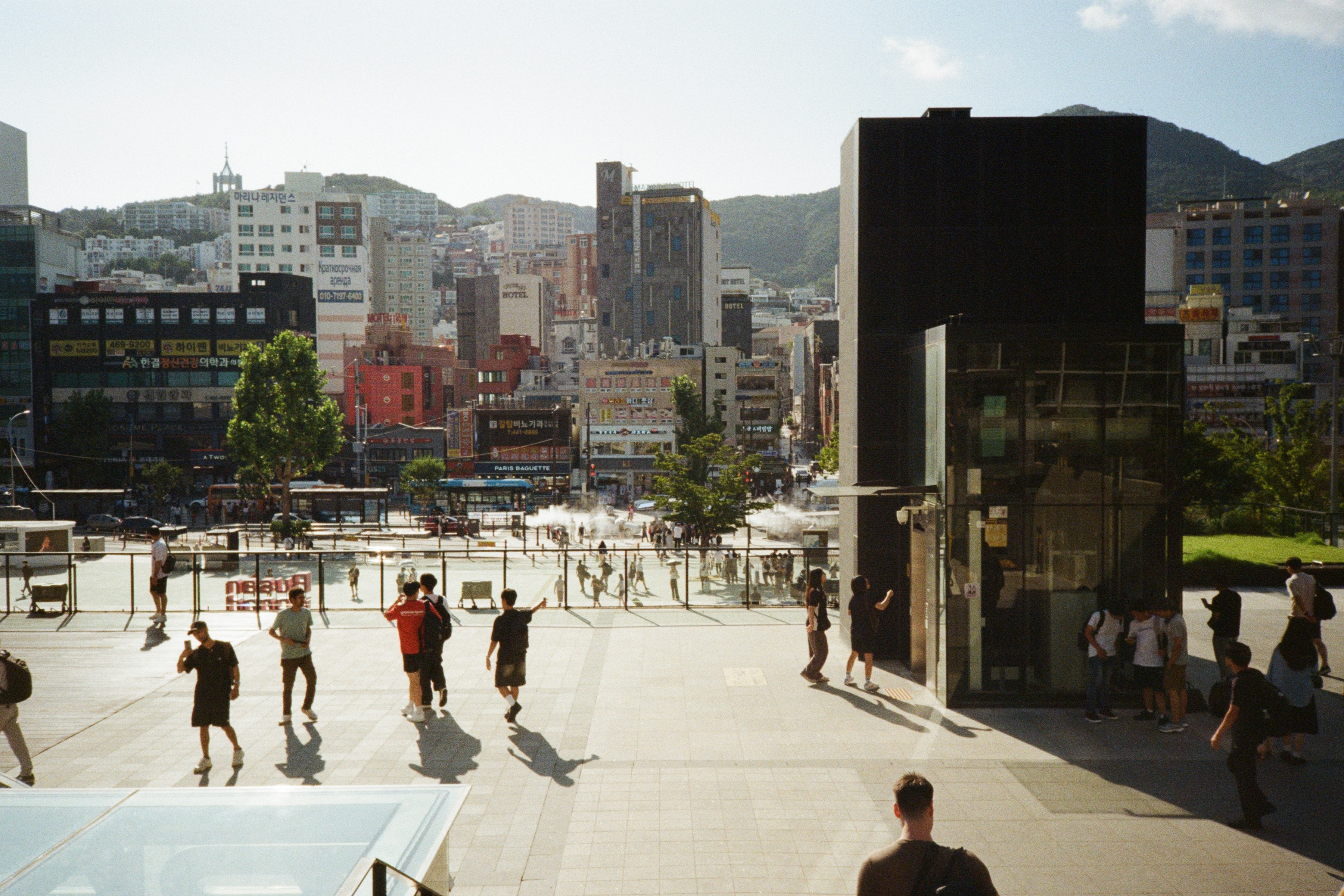 A group of people walking around a city