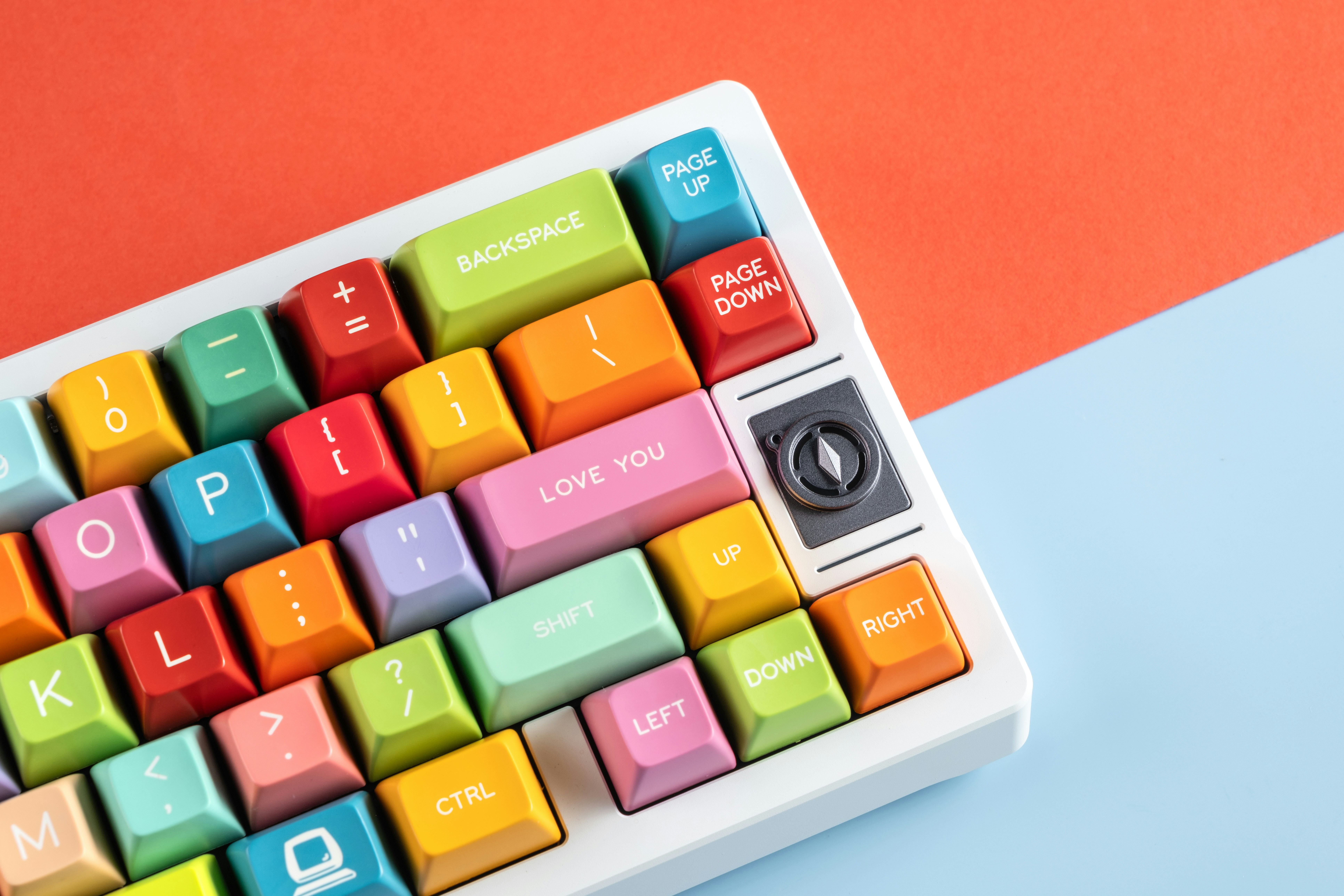 A colorful keyboard sitting on top of a blue and orange table