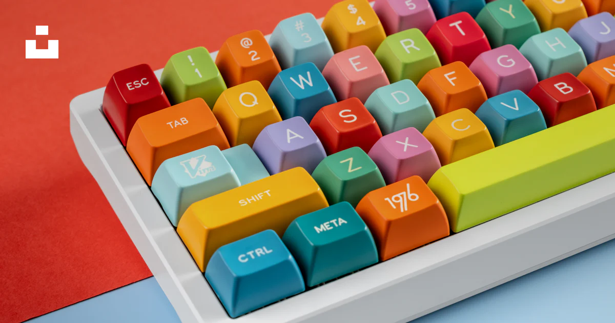 Computer Key Word Color A computer keyboard with colorful keys on a blue and red background ...